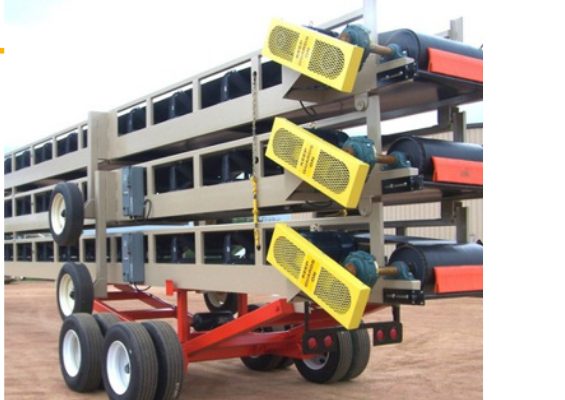 Stacked conveyor sections on running gear ready to ship